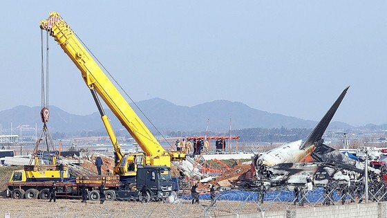 ２９日午前、務安国際空港の滑走路で旅客機が着陸に失敗する事故が発生した。写真は収拾作業が進められている事故現場の様子。キム・ギョンロク記者