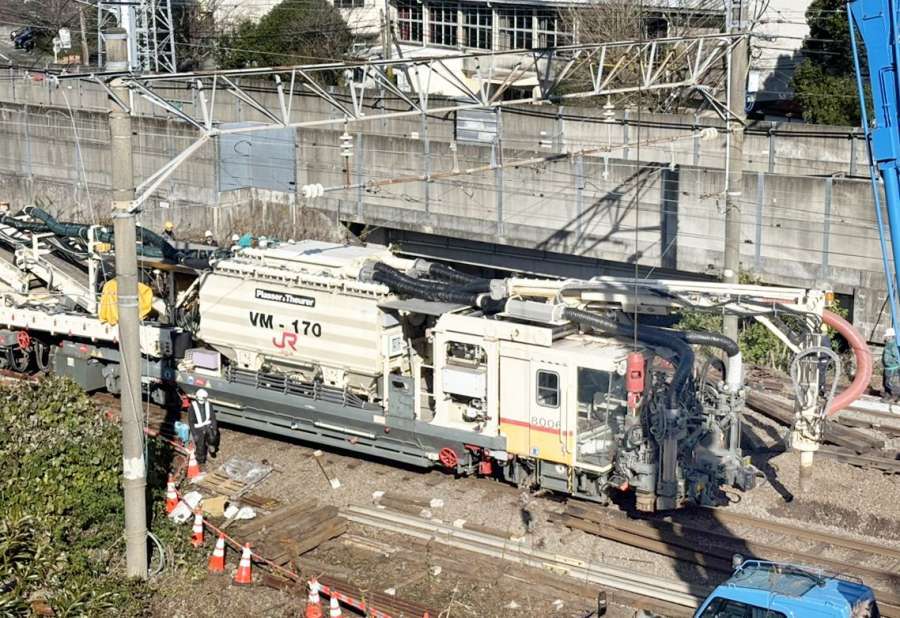 道床交換機で砕石を吸い上げる脱線現場＝２２日、薩摩川内市の川内駅付近