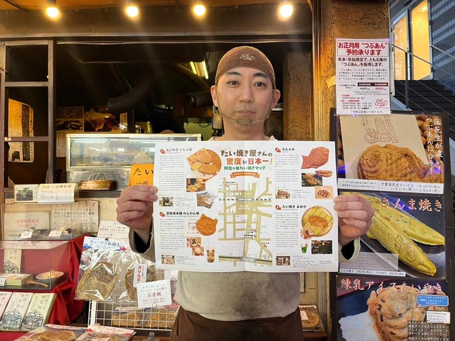 たい焼きマップを手にするたい焼き店「ともえ庵」の店長